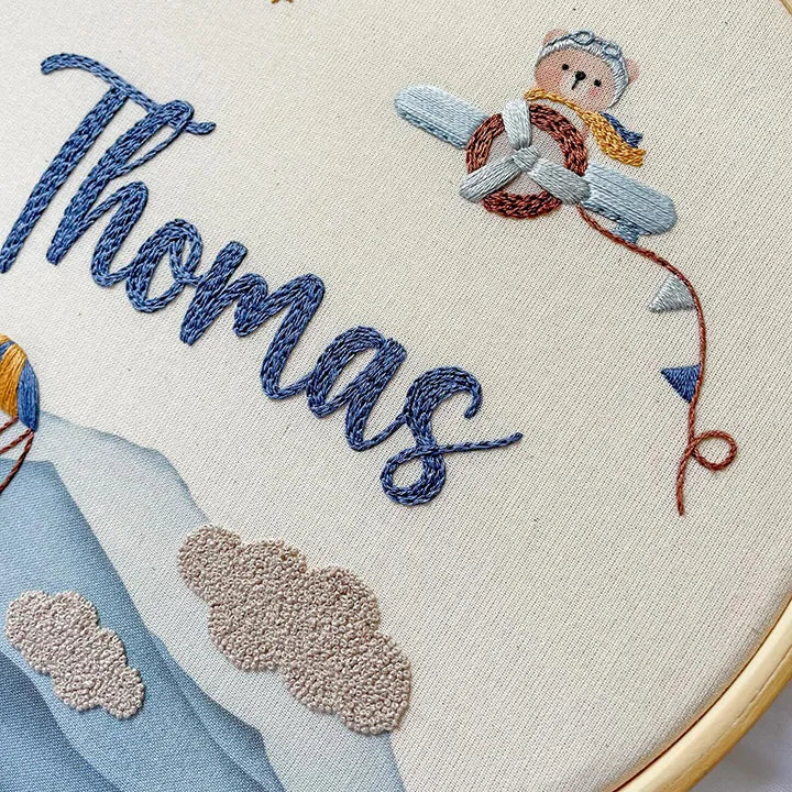 Childrens clock featuring hand-embroidered bear