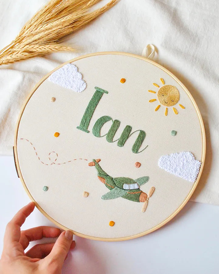 Custom airplane wall clock showing detailed aviation embroidery work