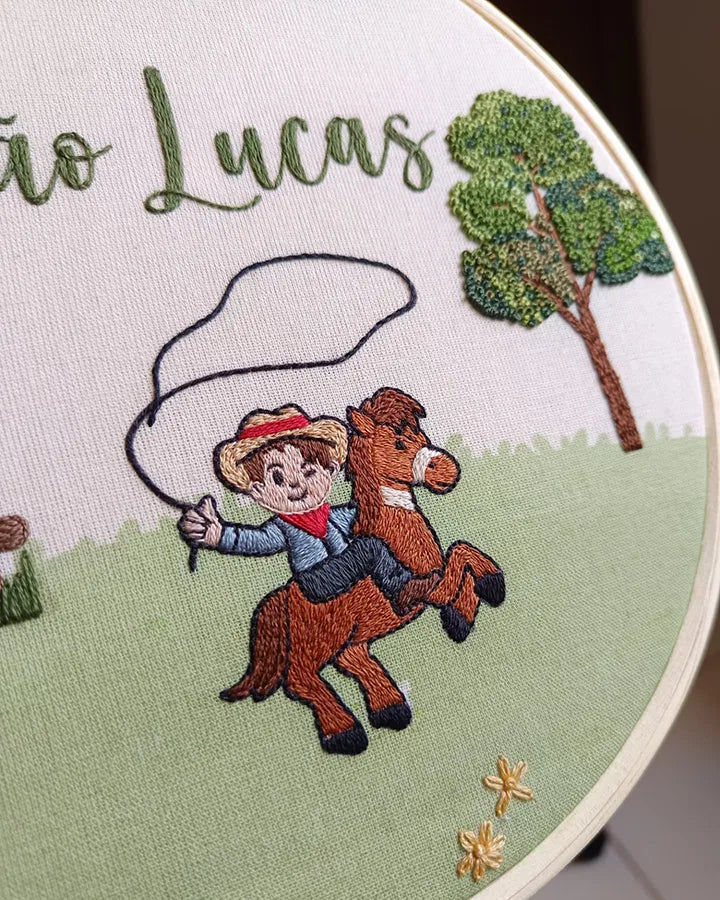 Embroidery hoop with a cowboy and horse design, featuring the name