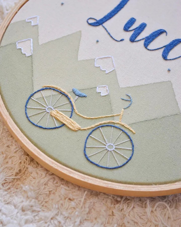 Embroidery hoop with a embroidered design of a bicycle 