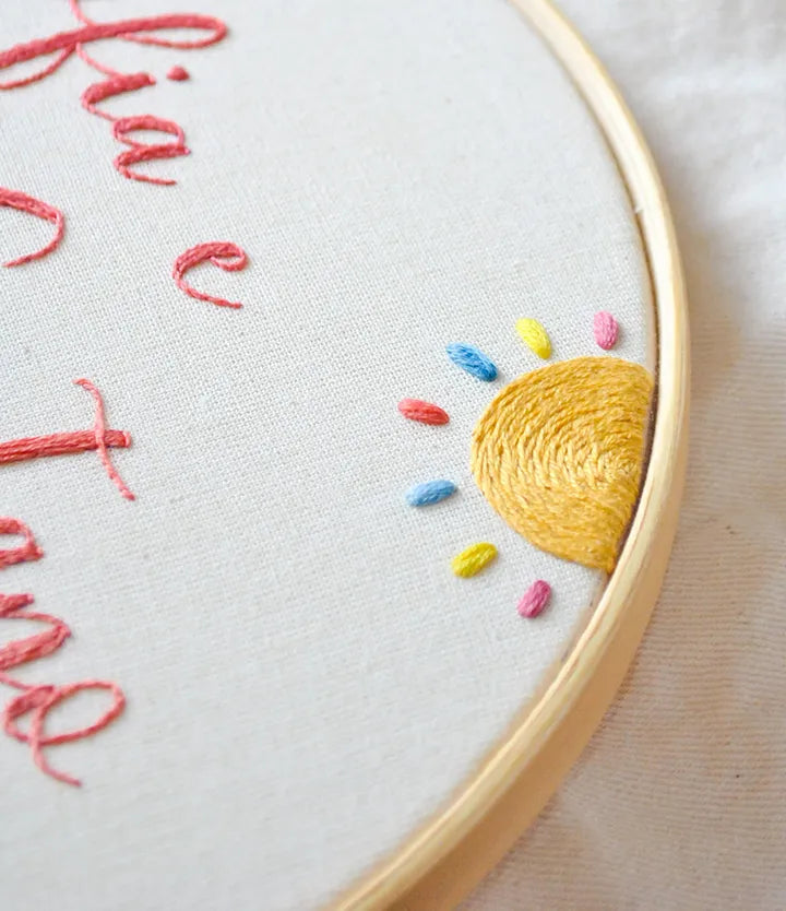 Embroidery hoop with a yellow sun