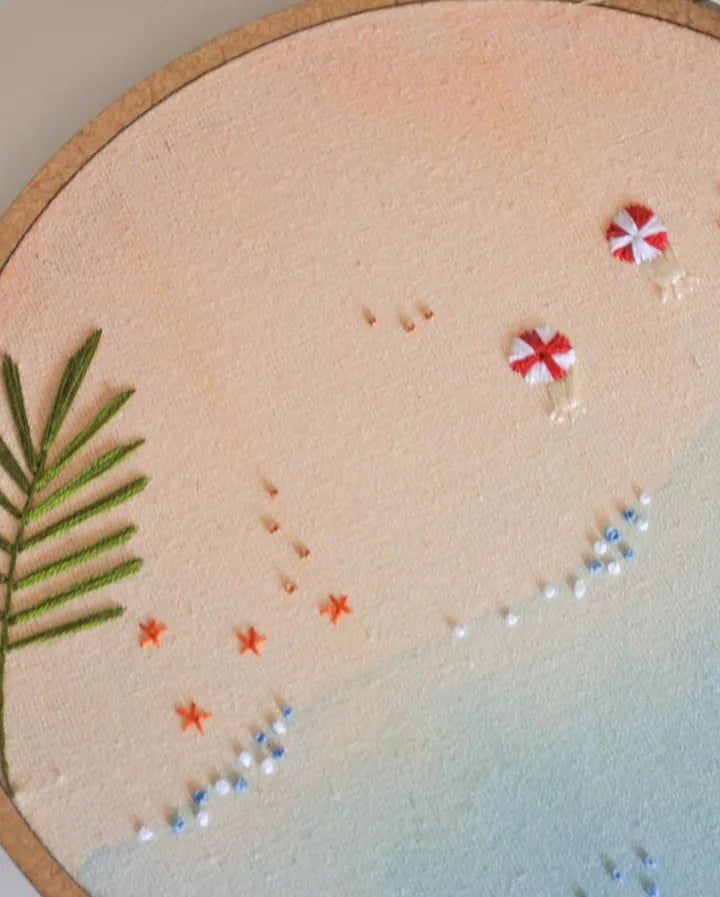 Embroidery hoop with beach-themed design