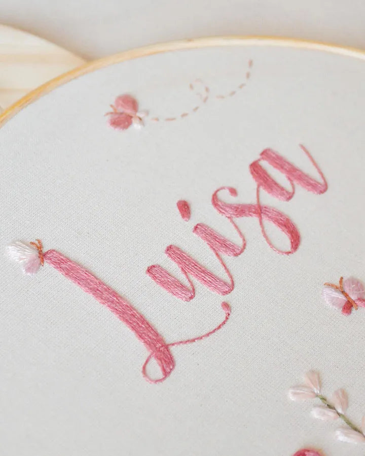 Embroidery hoop with name embroidered in pink thread