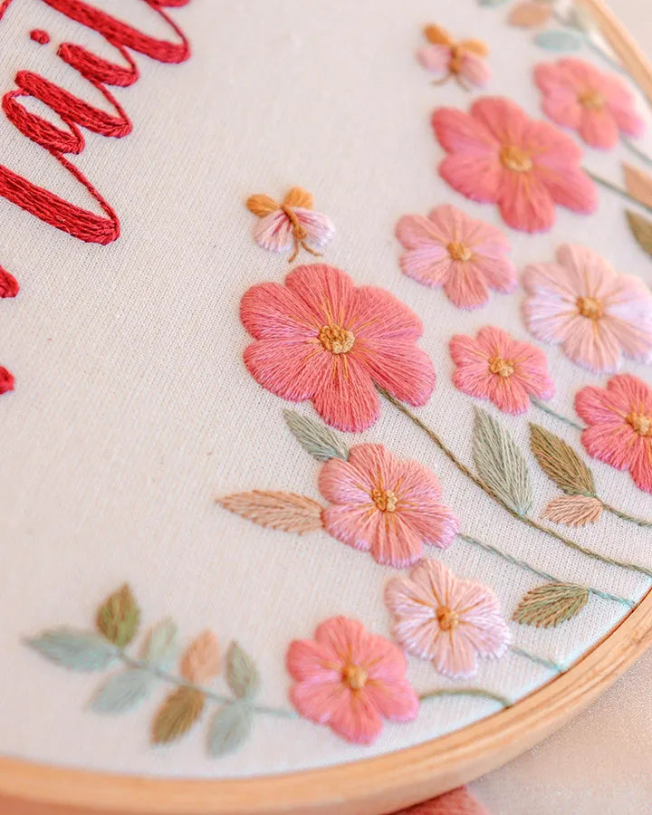 Embroidery hoop with pink flowers close up