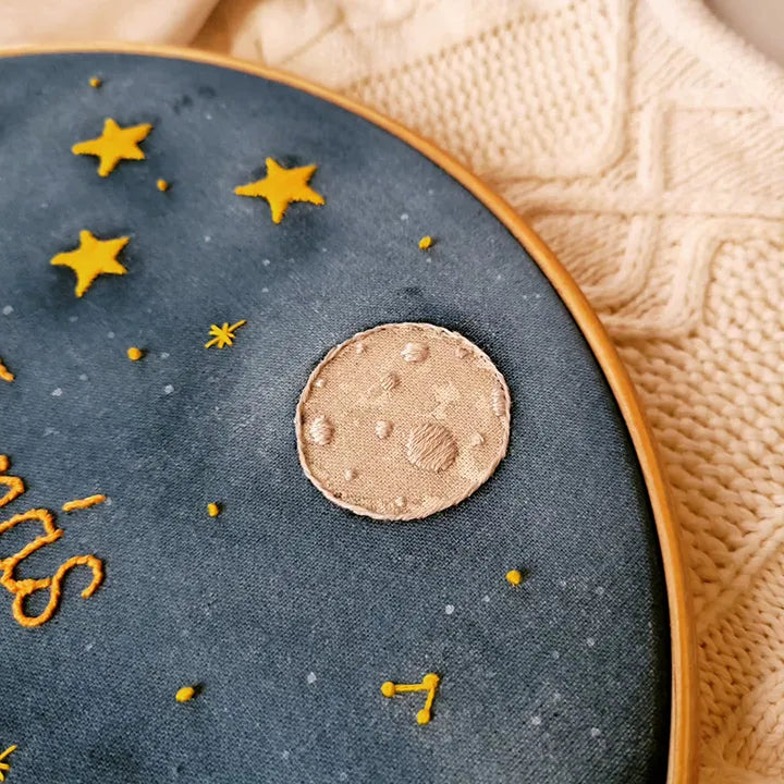 Embroidery hoop with star and moon design