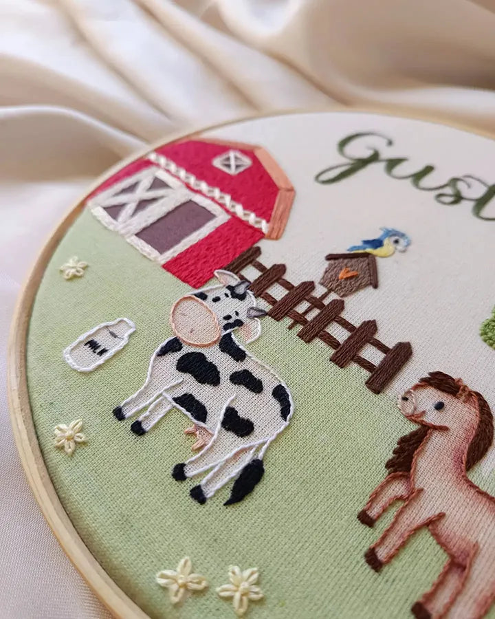 Farmhouse clock with custom name embroidered in green thread on country scene