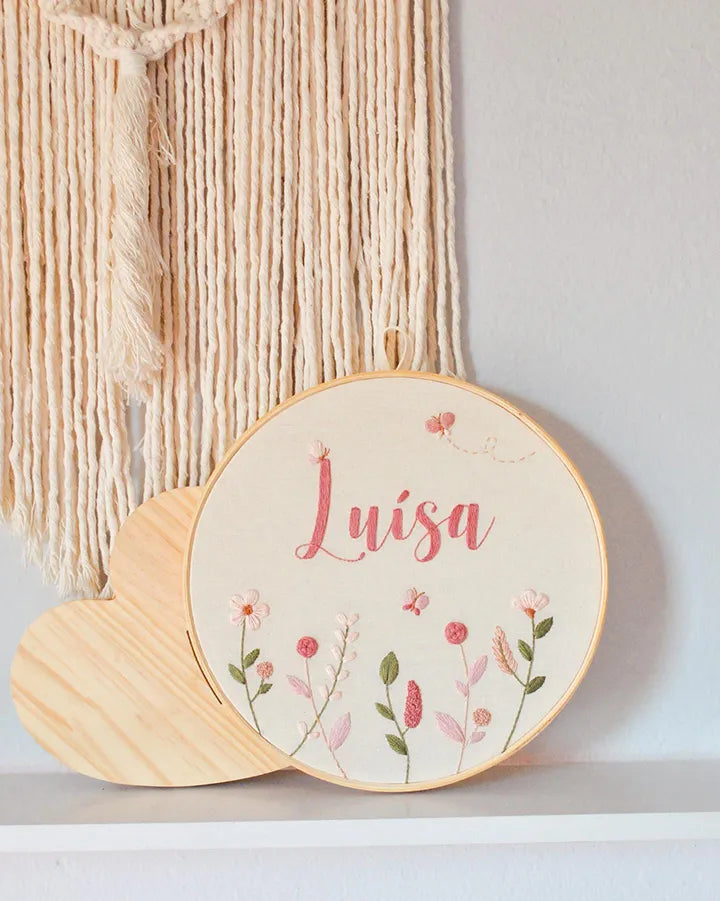 Decorative hoop with embroidered name and floral patterns