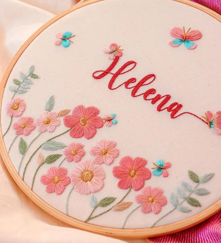 Embroidery hoop with floral butterfly design and embroidered name